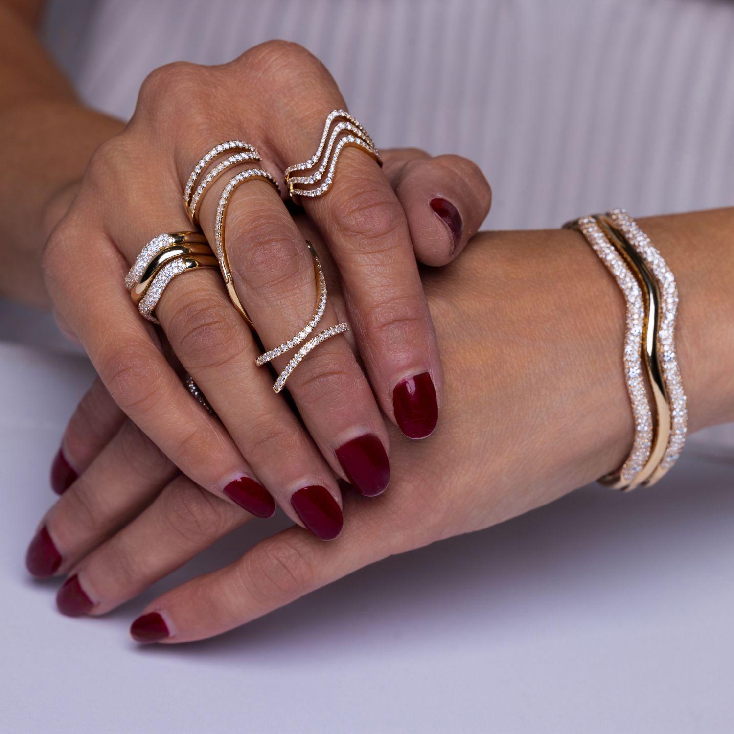 Triple row chevron bands stacked on hand showing stackable ring styling