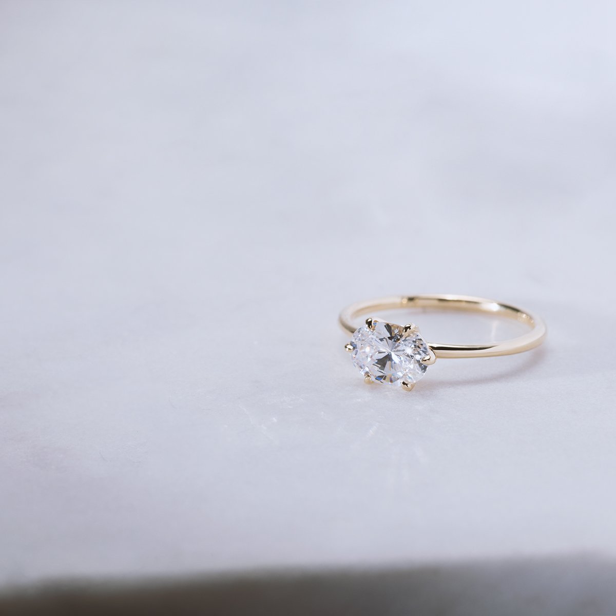 East - West Hidden Halo Engagement Ring