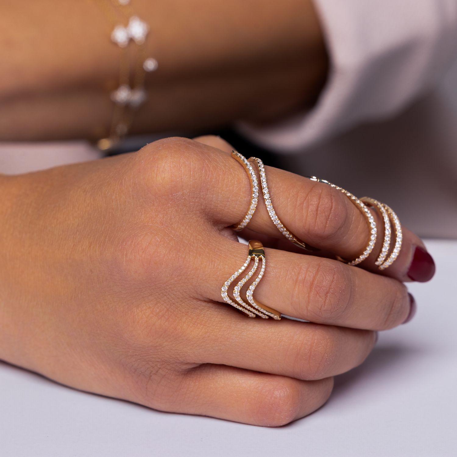 Chevron pave bands layered on fingers showing mix and match styling