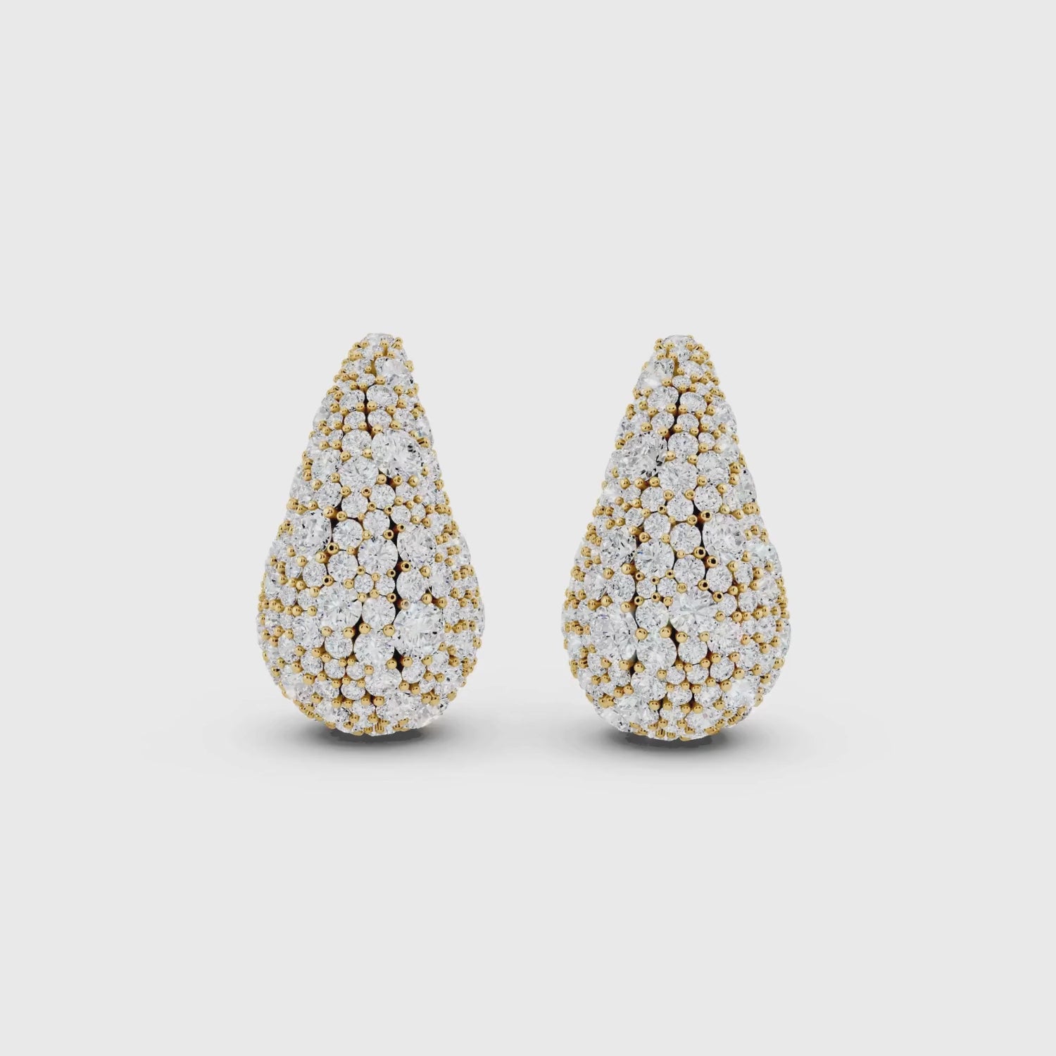 Close-up video of yellow gold pave diamond teardrop studs showing sparkle detail 