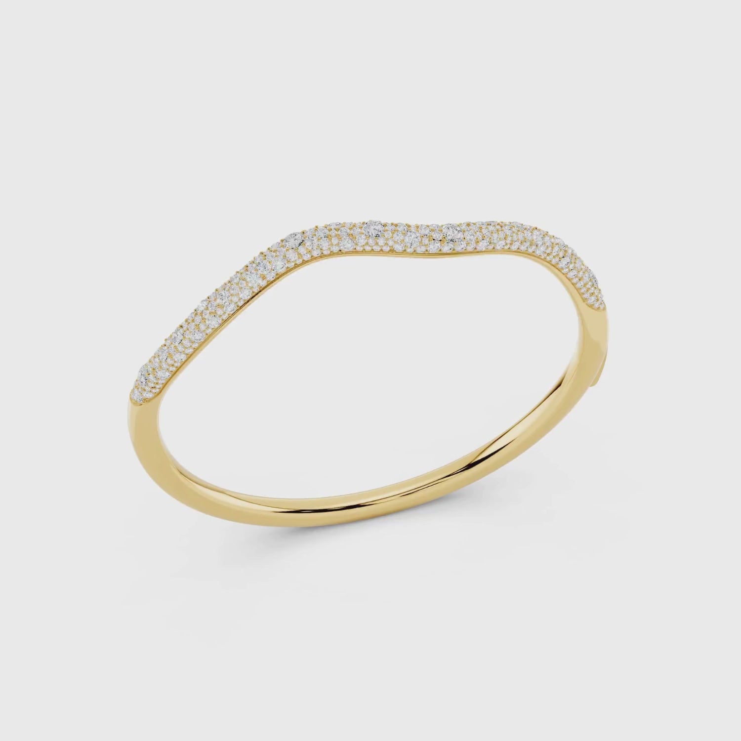 Yellow gold diamond wave pave bangle showing sparkle detail video.