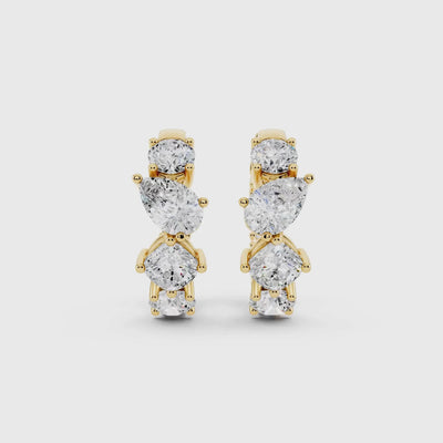 Close-up of yellow gold oval diamond huggie hoop showing sparkle detail video